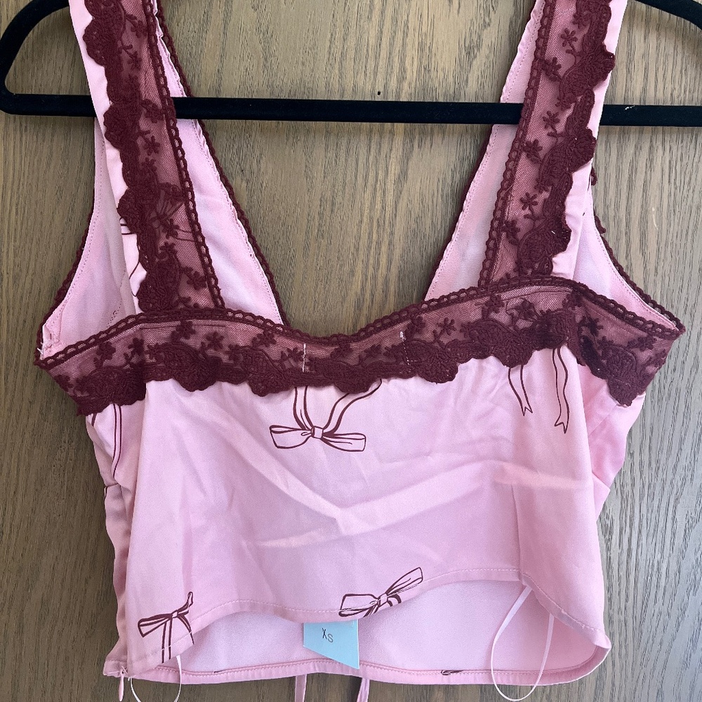 Stella Laguna Beach pink lace bow top
